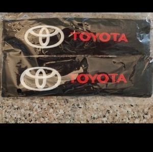 2 new Toyota embroidered seat belt covers.